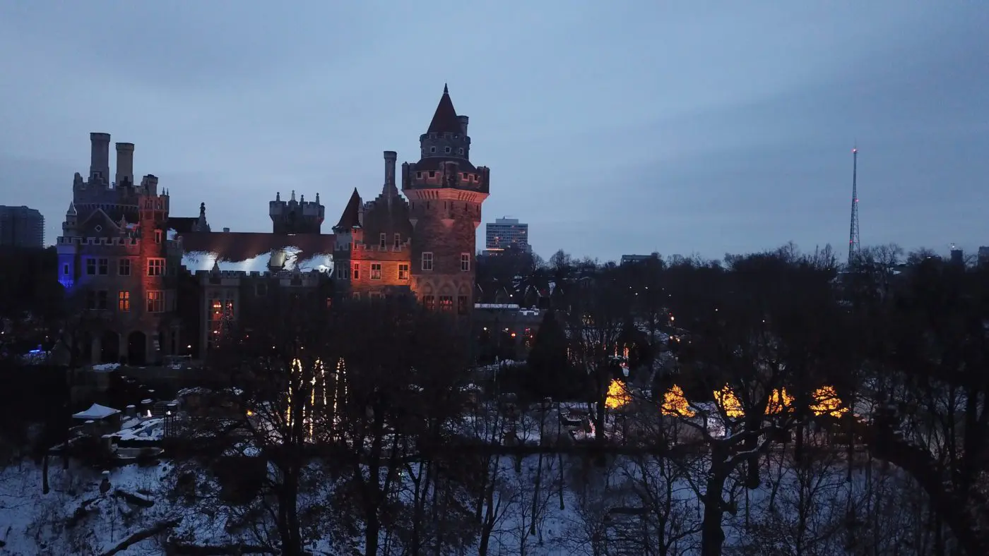 view of a castle at night, lit up and surrounded by trees | haunted places in ontario