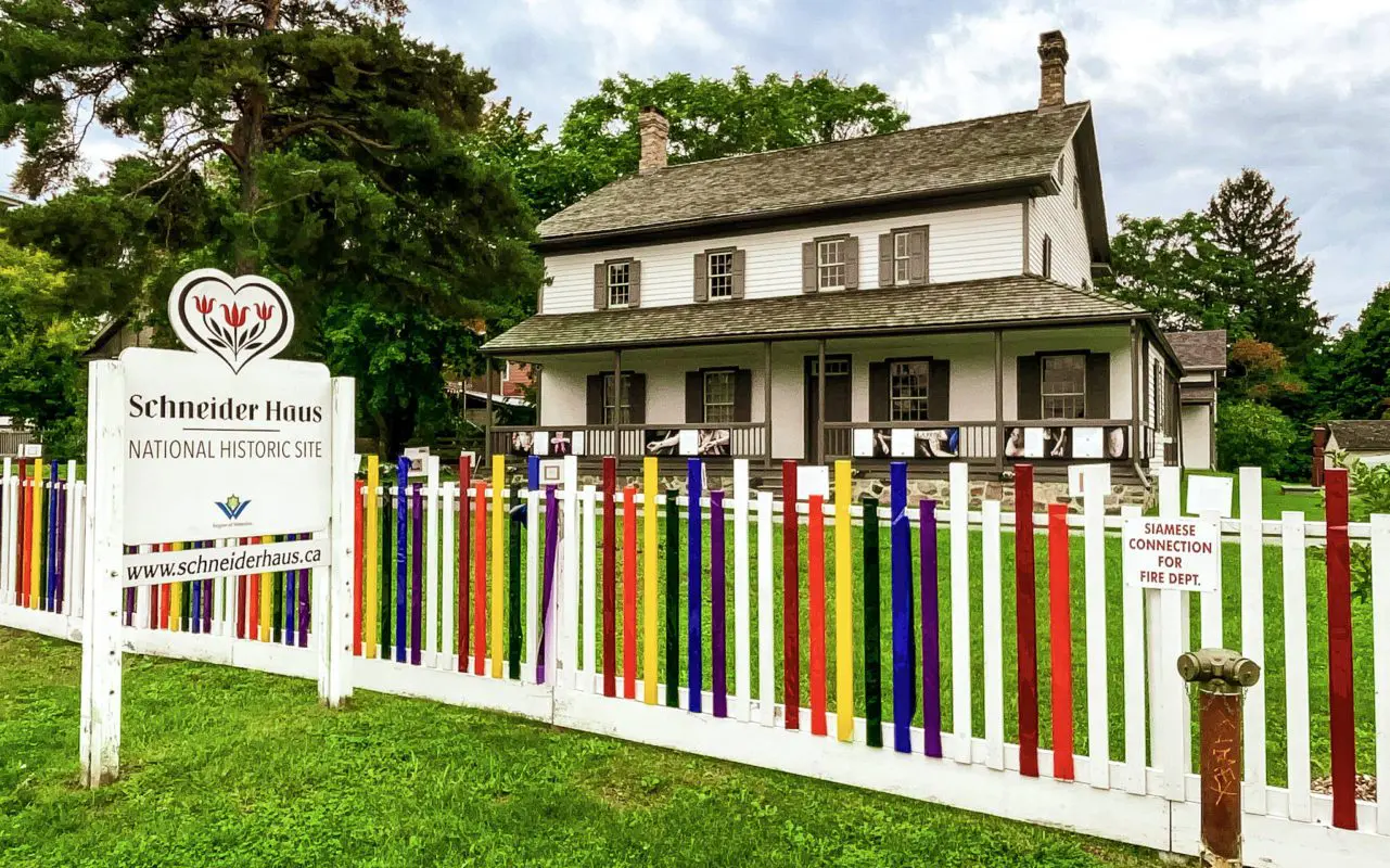 historic white home with multicoloured fence | downtown kitchener