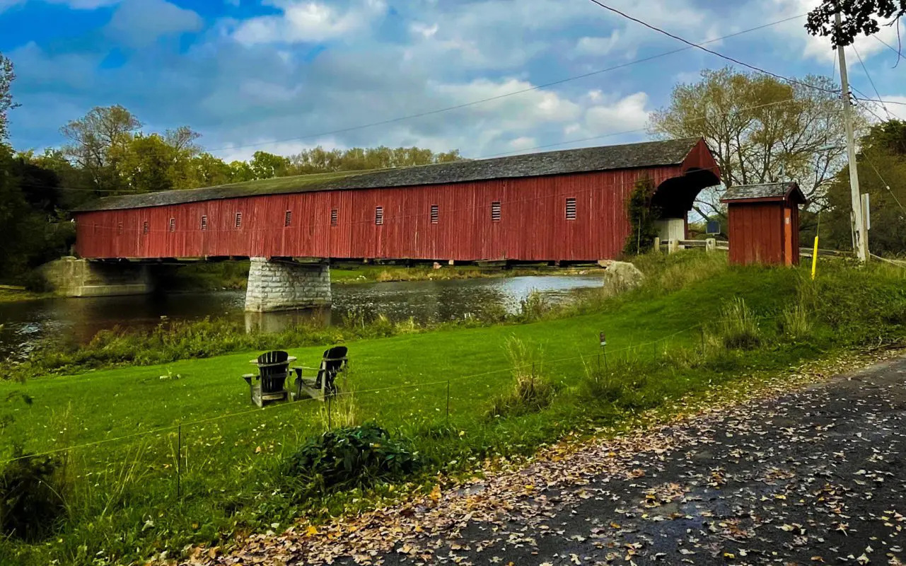 wooden covered bridge over a river | places to go in waterloo