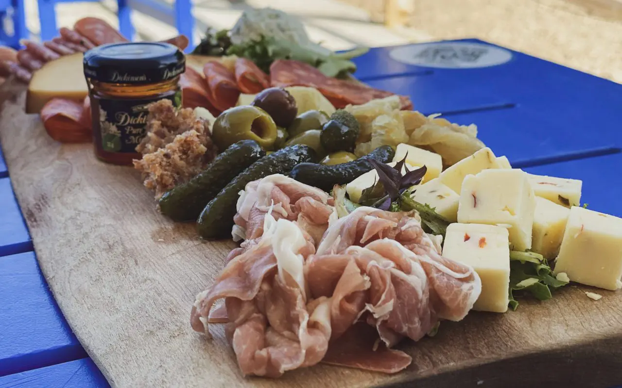 a charcouterie board with pickles, meats, and cheese | best restaurants collingwood