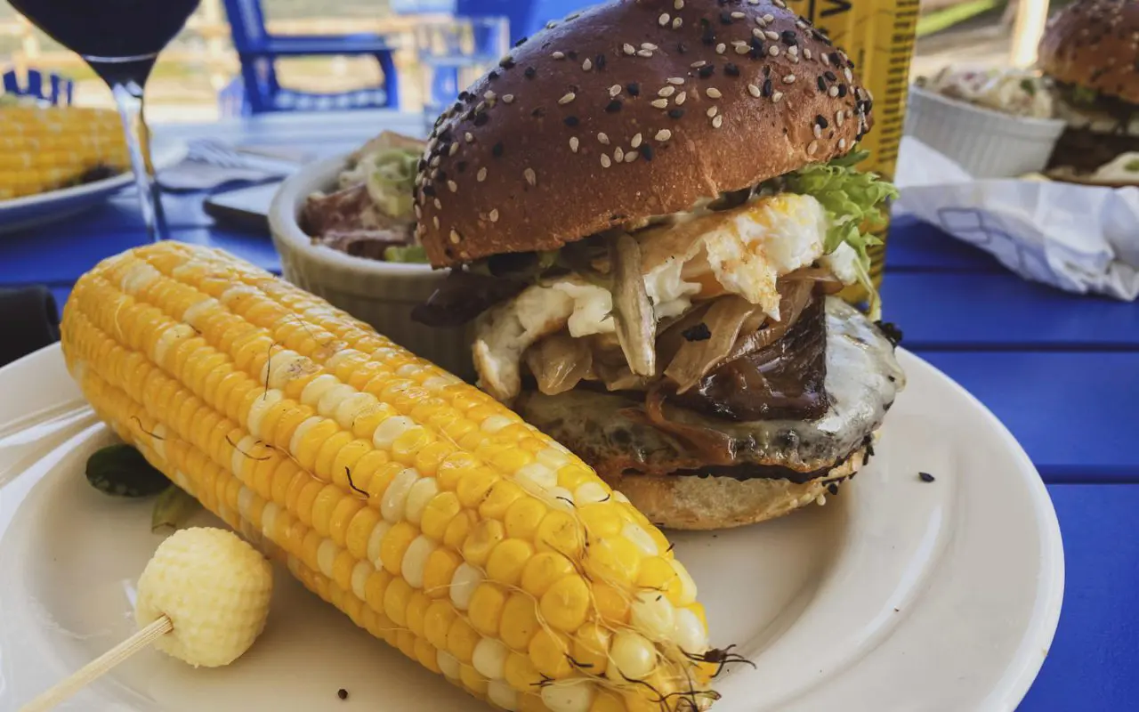 dinner plate with a burger and a cob of corn | best restaurants collingwood