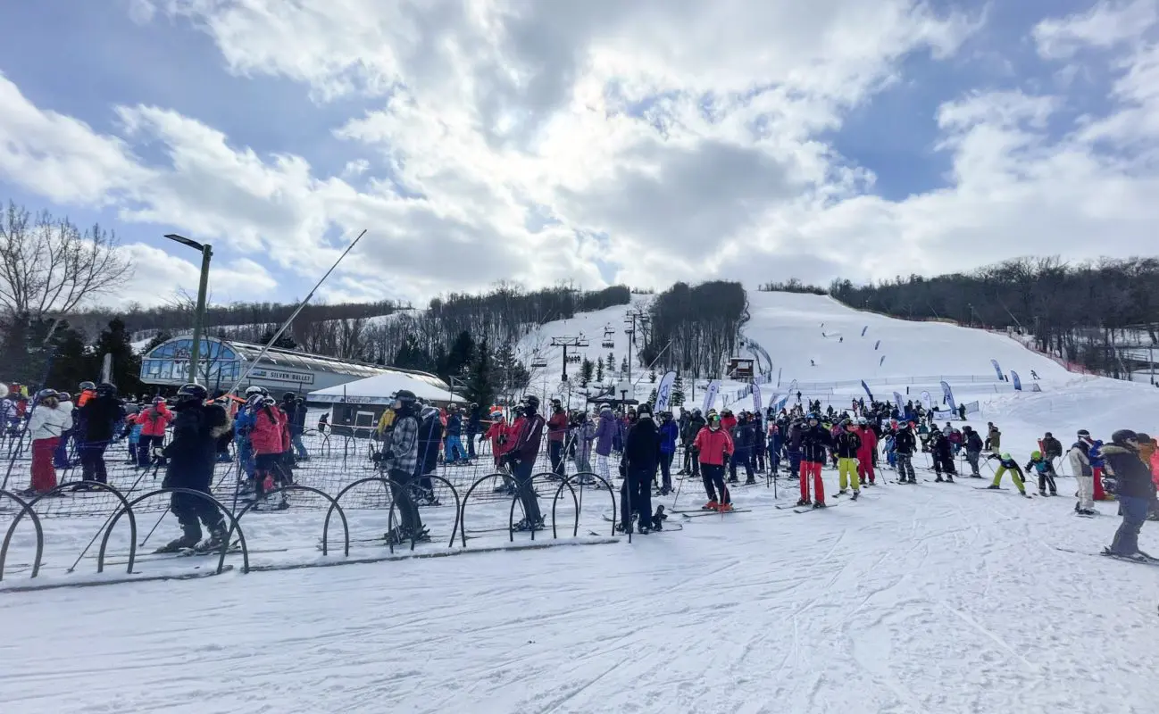 several people at the base of a ski hill | blue mountain village collingwood