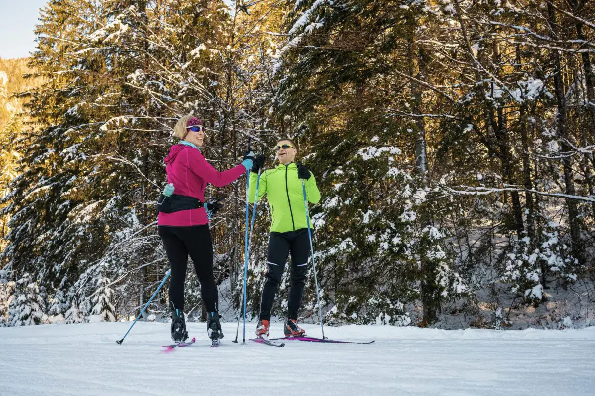 two people standing on a cross-country ski trail, talking | best skiing in ontario