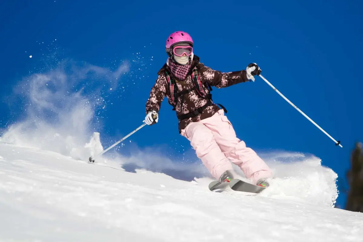 a person dressed in winter gear skiing | ski hills in ontario