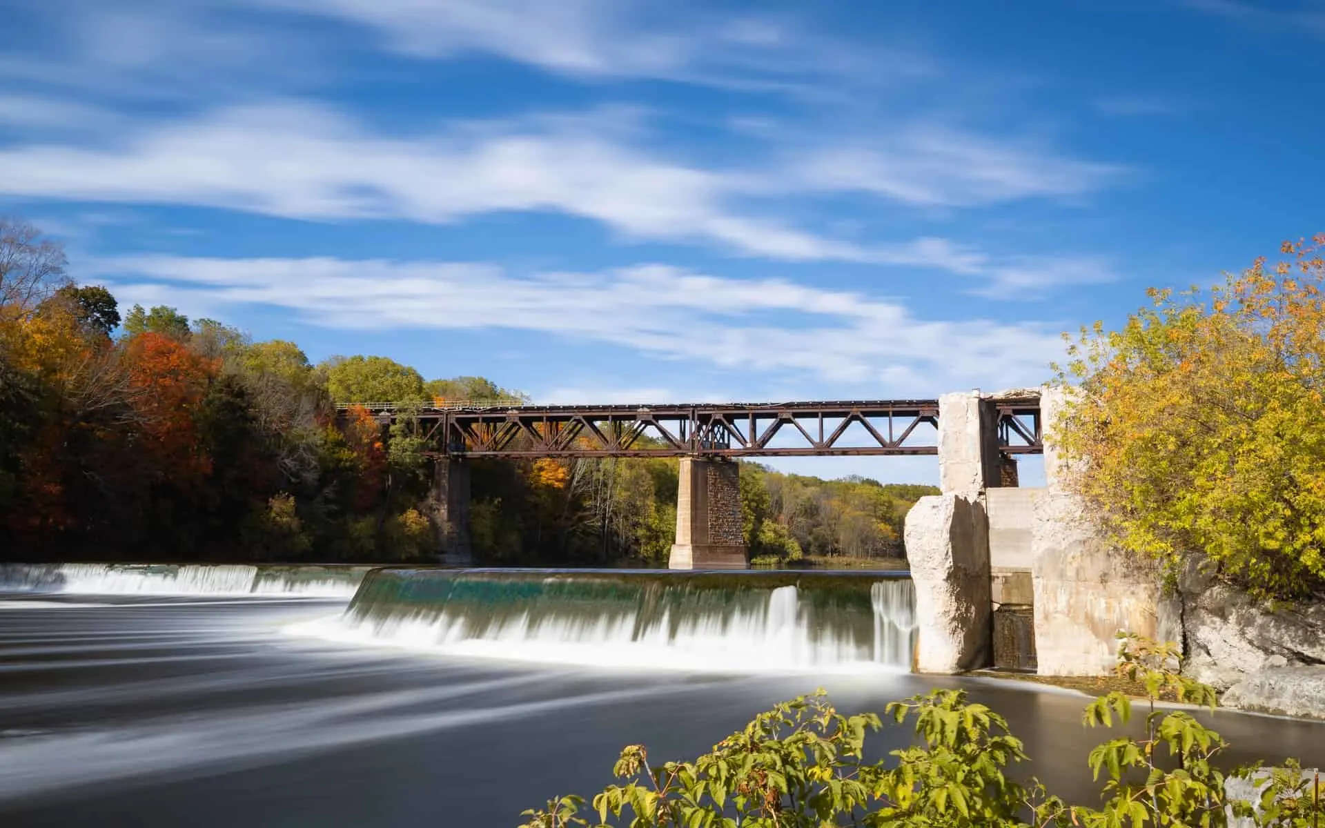 railway bridge over a dam in the fall | day trips from toronto