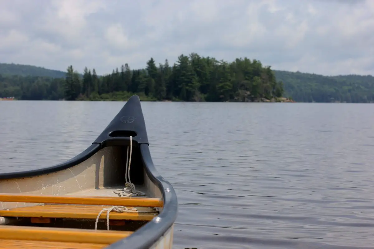 front of a canoe on a lake | places to visit in ontario in fall