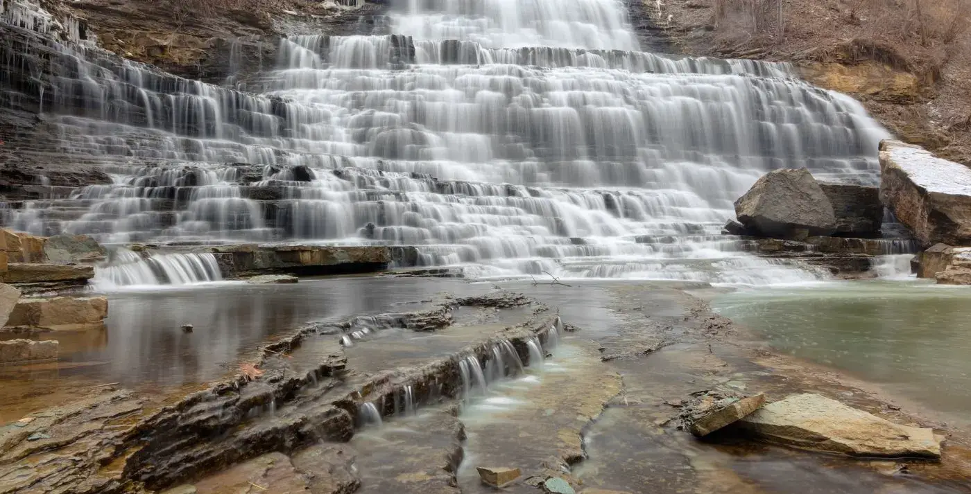 base of a waterfall surrounded by rock | places to visit in fall in ontario