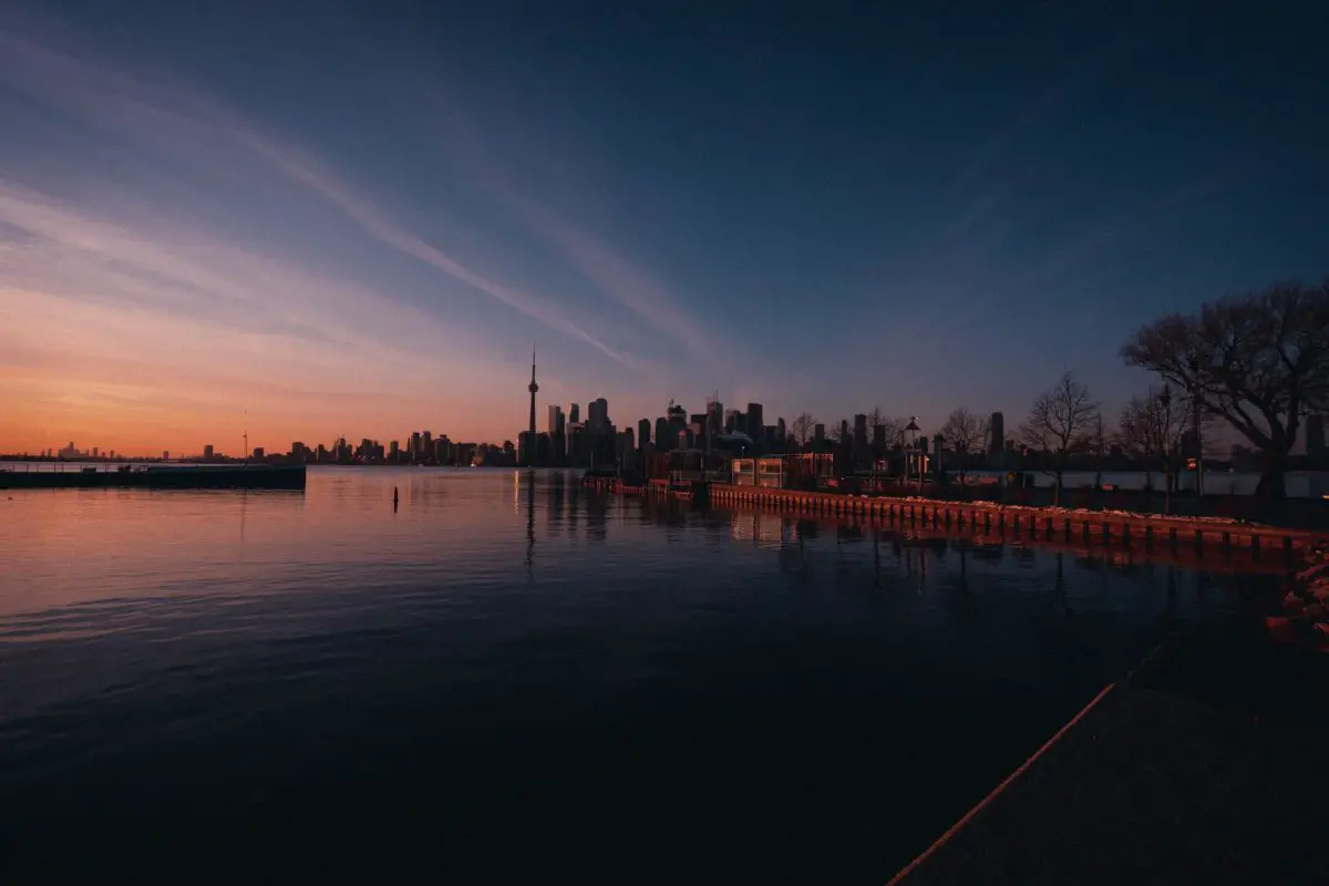 view of the Toronto skyline from the water at sunset | haunted places ontario