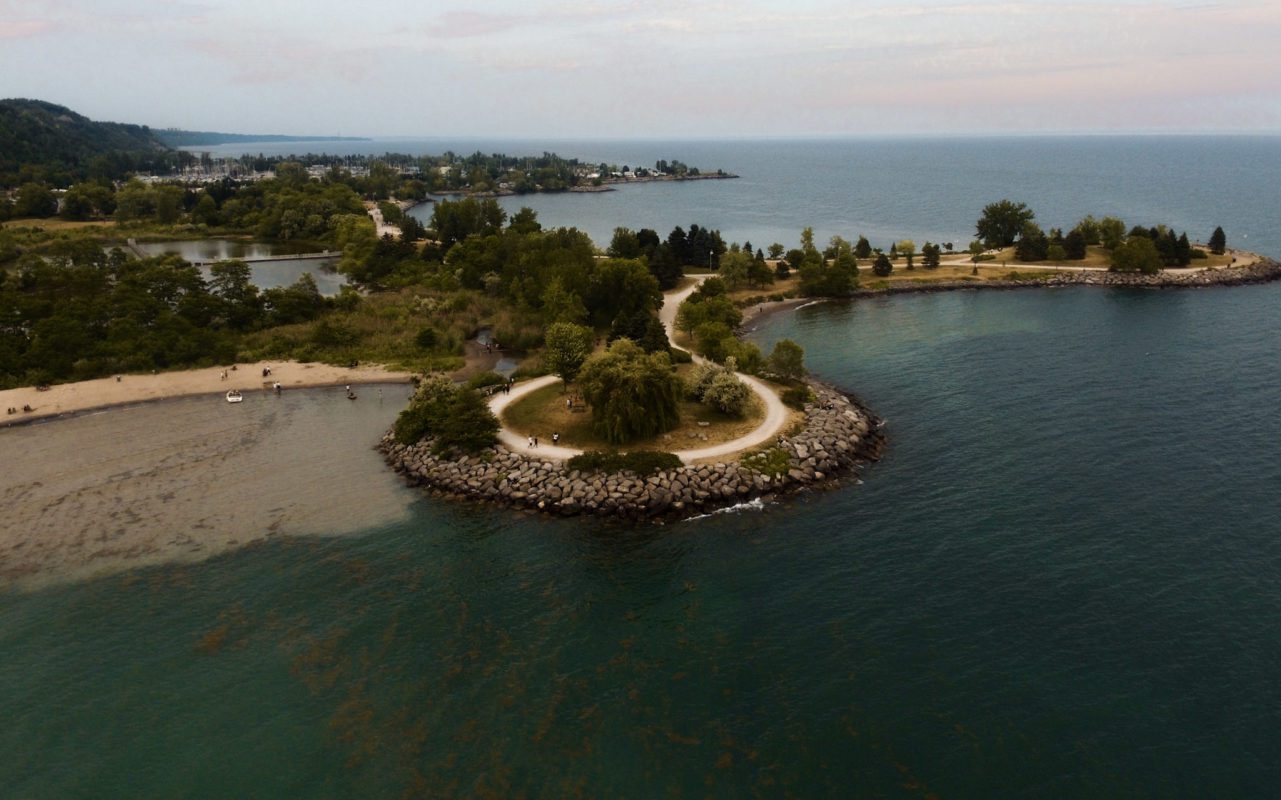 birds eye view of a sandy beach and pathway through a Toronto green space | best beaches in ontario for swimming